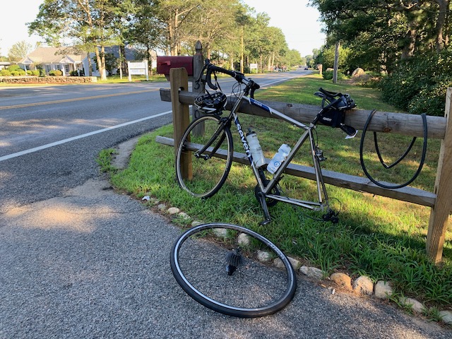 A bicycle parked on the side of a road
Description automatically generated