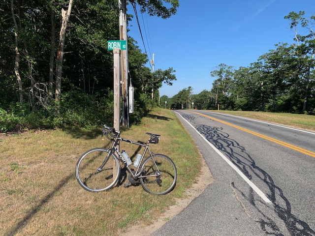 A bicycle parked on the side of a road
Description automatically generated