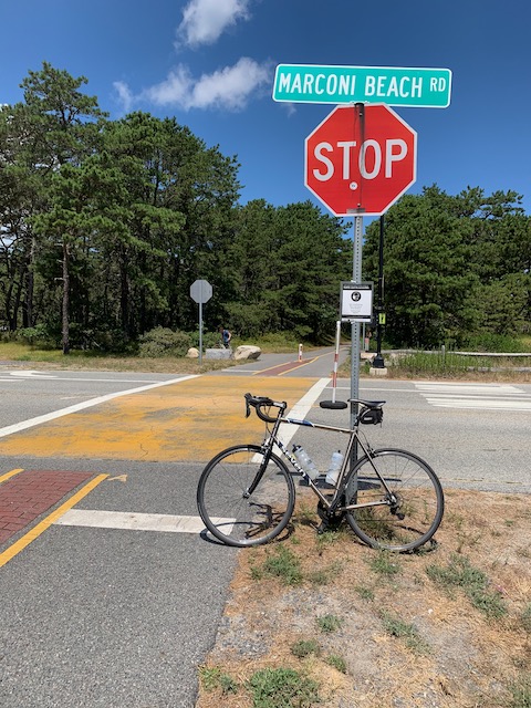A stop sign on street next to a bicycle
Description automatically generated